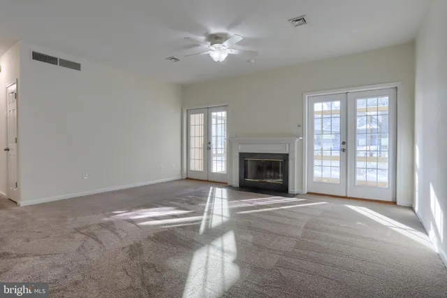 a view of livingroom with fireplace fan and windows