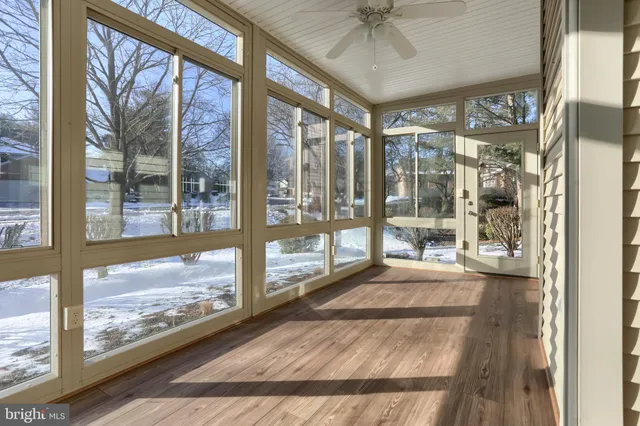 a large room with wooden floor and windows