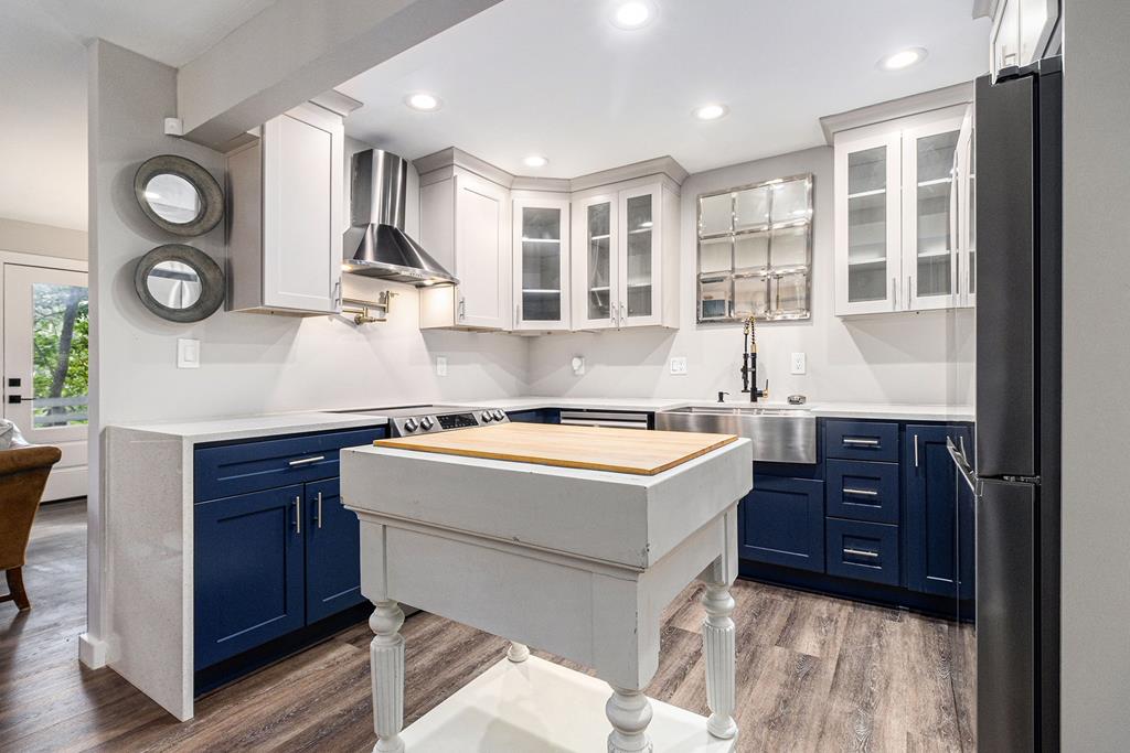 a view of a kitchen with a sink and wooden floor
