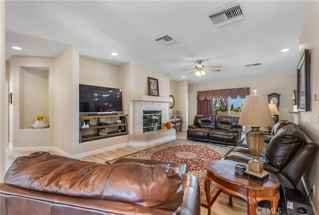 a living room with lots of furniture and kitchen view