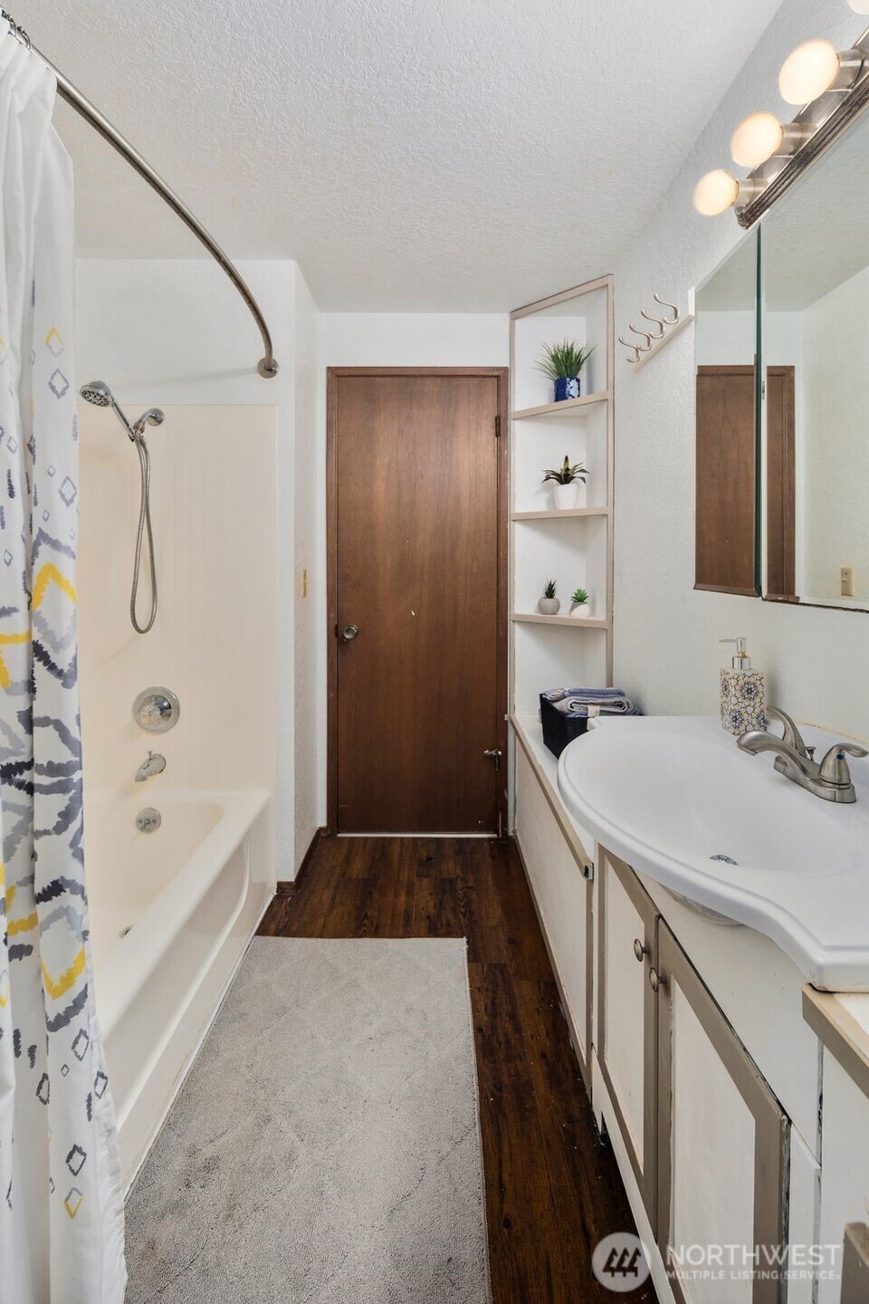 17464 Dunbar Road, Unit 1 Mount Vernon, WA 98273 - Photo 24 of 40 a bathroom with a granite countertop sink a mirror and a bathtub