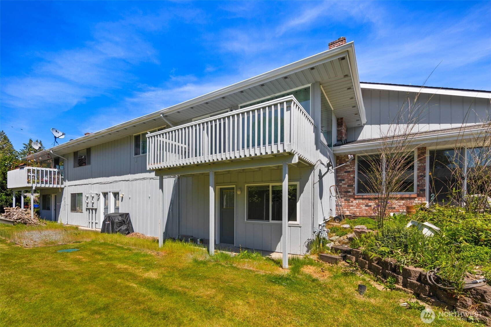 17464 Dunbar Road, Unit 1 Mount Vernon, WA 98273 - Photo 32 of 40 a view of a house with a large window and potted plants