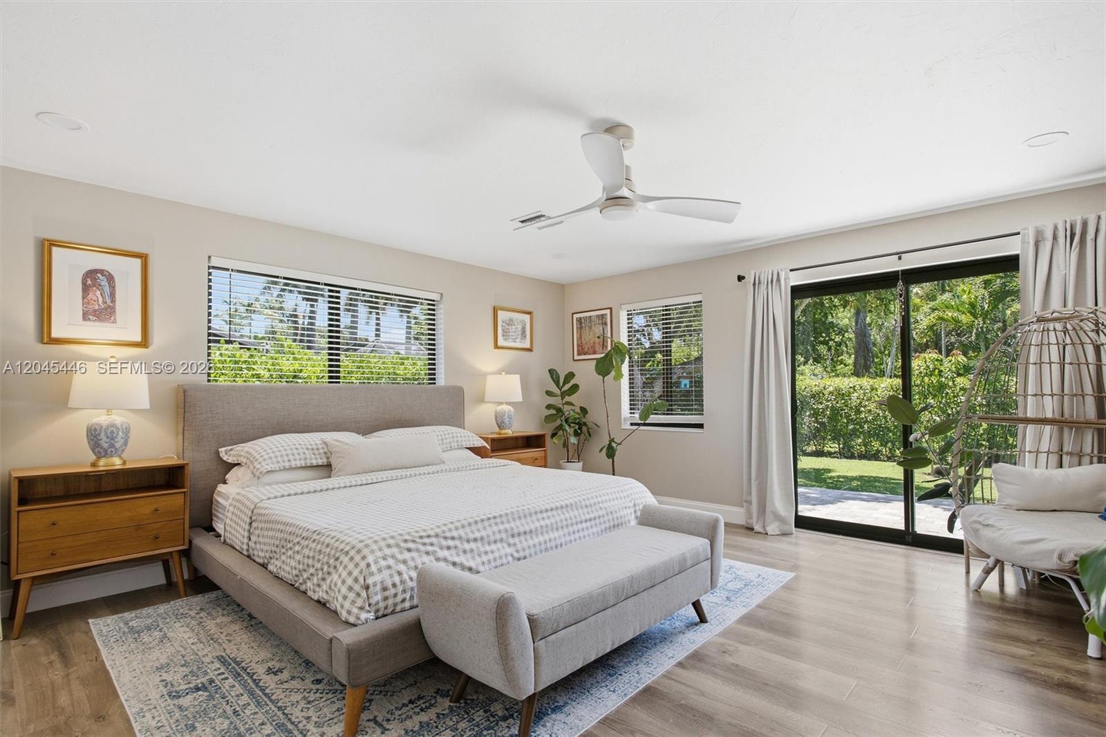 8440 Southwest 180th Street Palmetto Bay, FL 33157 - Photo 19 of 54 a bedroom with a large bed and a large window