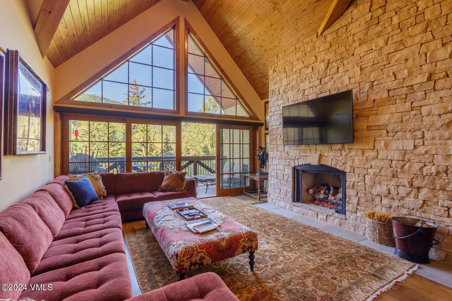 434 South Frontage Road East, Unit 402 Vail, CO 81657 - Photo 1 of 44 a living room with furniture a fireplace and a flat screen tv