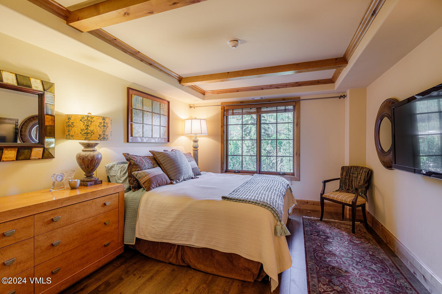 434 South Frontage Road East, Unit 402 Vail, CO 81657 - Photo 11 of 44 a bed room with a bed a mirror and a window