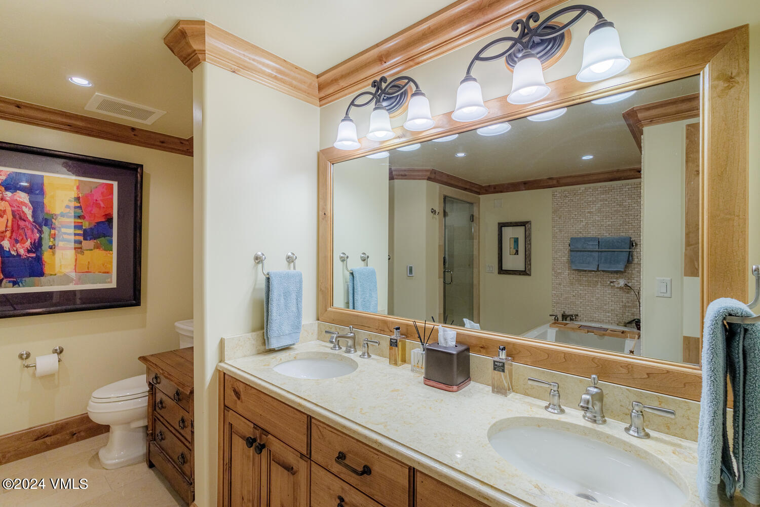 434 South Frontage Road East, Unit 402 Vail, CO 81657 - Photo 12 of 44 a bathroom with a granite countertop sink a toilet and a mirror