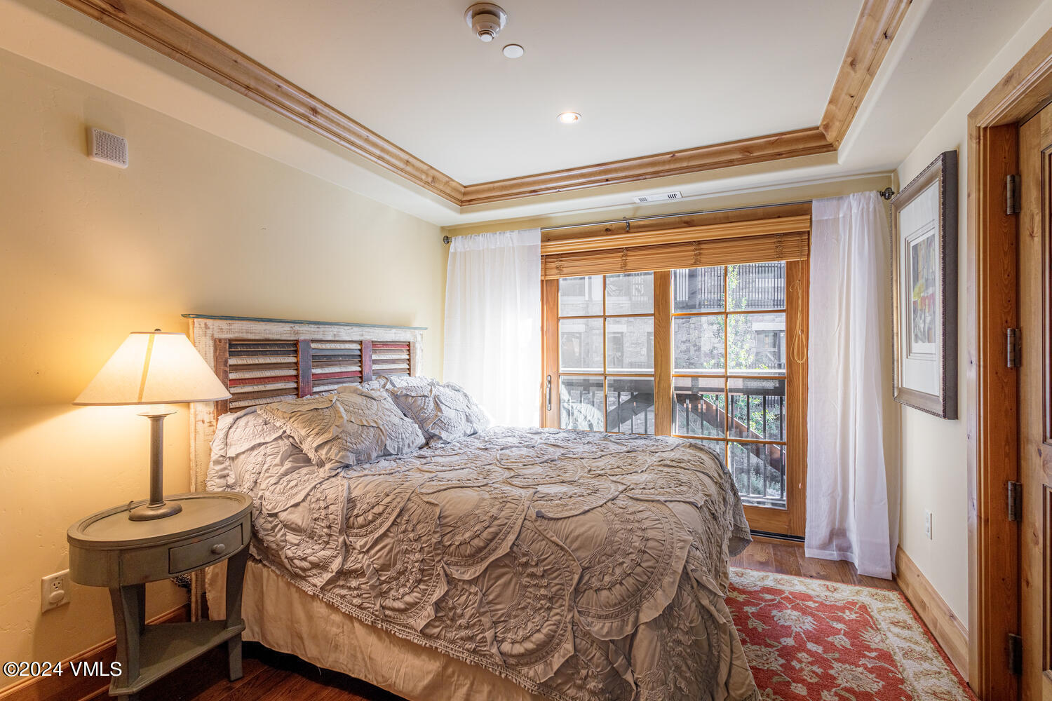 434 South Frontage Road East, Unit 402 Vail, CO 81657 - Photo 17 of 44 a bedroom with a bed and a lamp on dresser