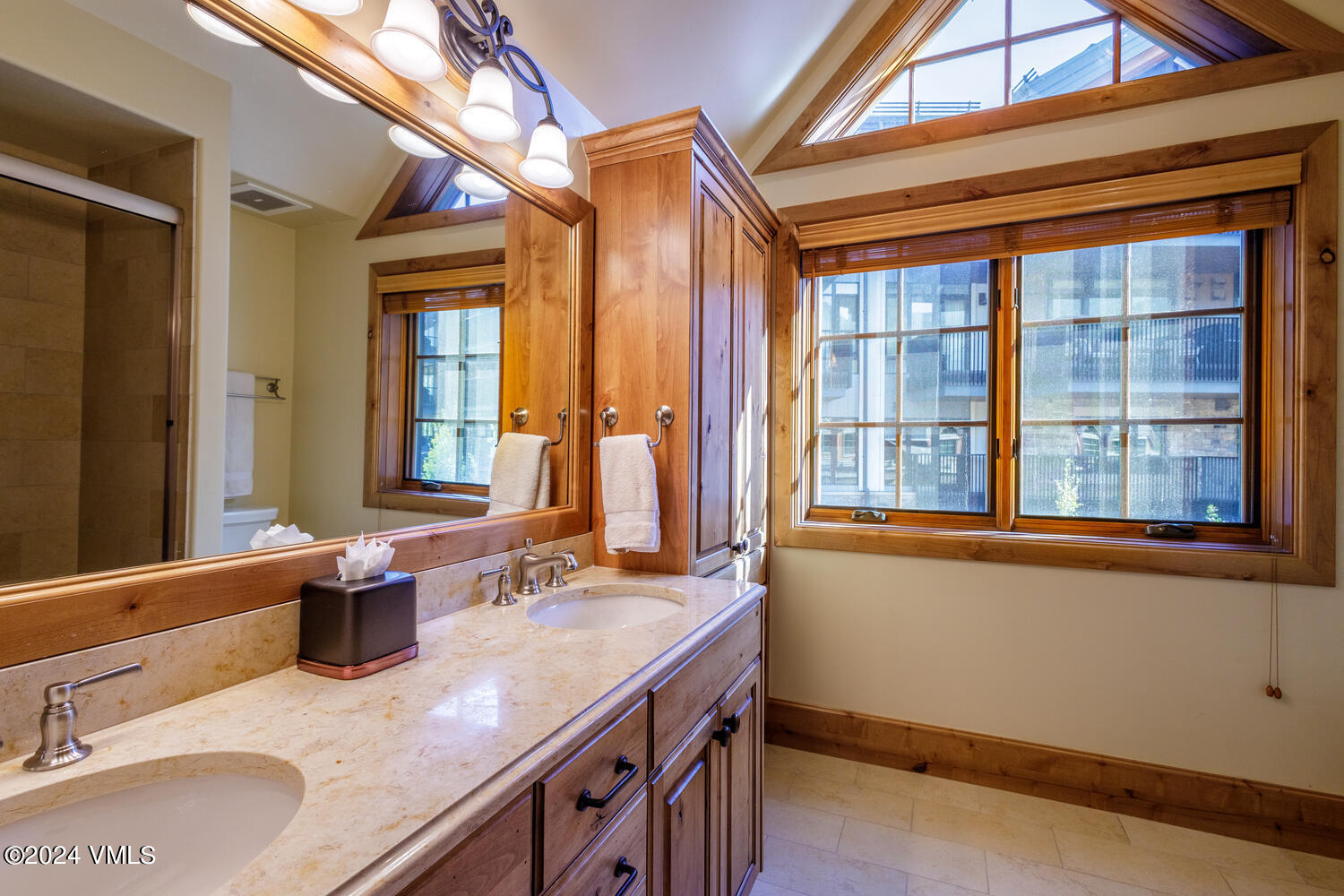 434 South Frontage Road East, Unit 402 Vail, CO 81657 - Photo 20 of 44 a bathroom with a granite countertop sink and a large mirror