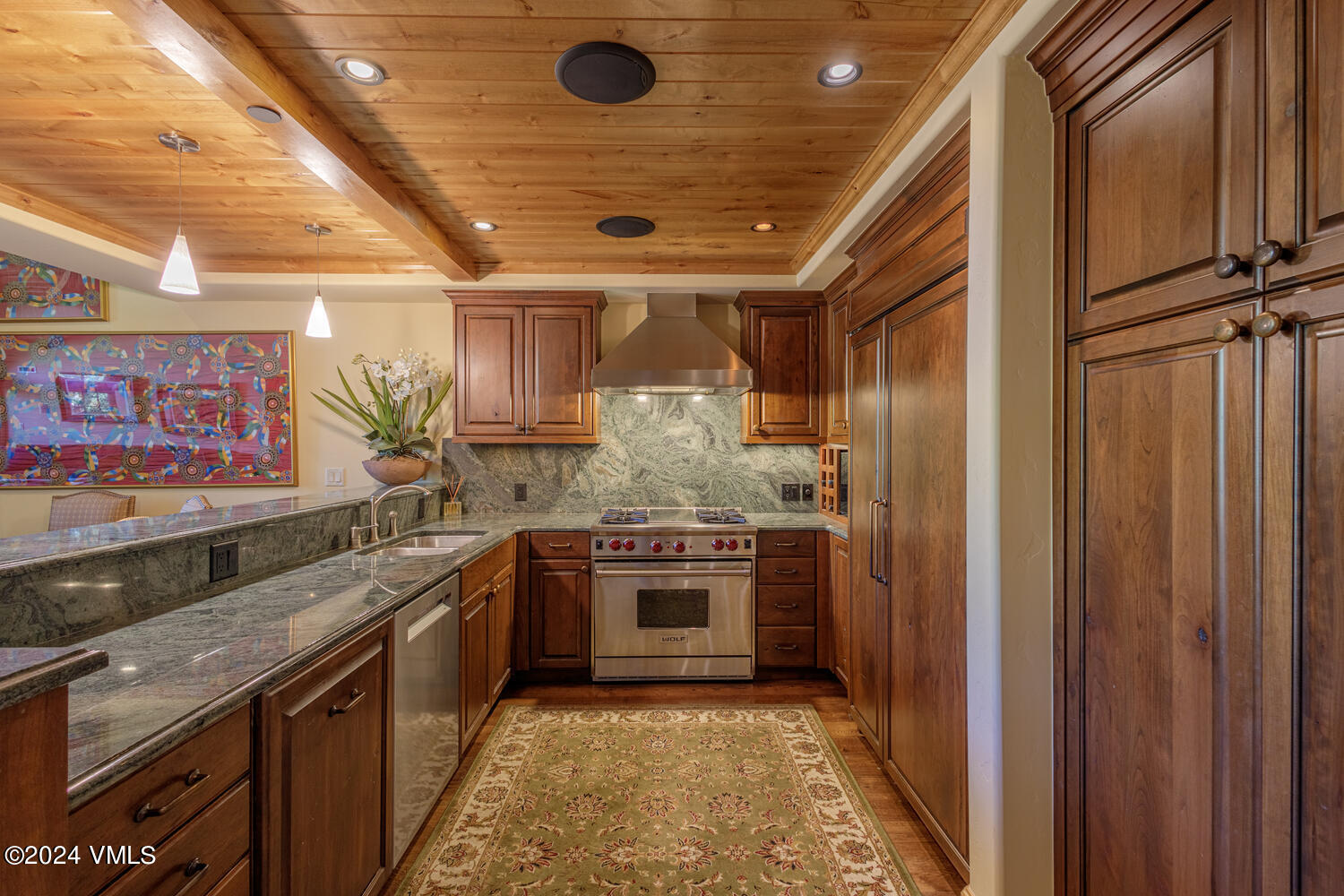 434 South Frontage Road East, Unit 402 Vail, CO 81657 - Photo 10 of 44 a large kitchen with stainless steel appliances granite countertop a stove and a refrigerator