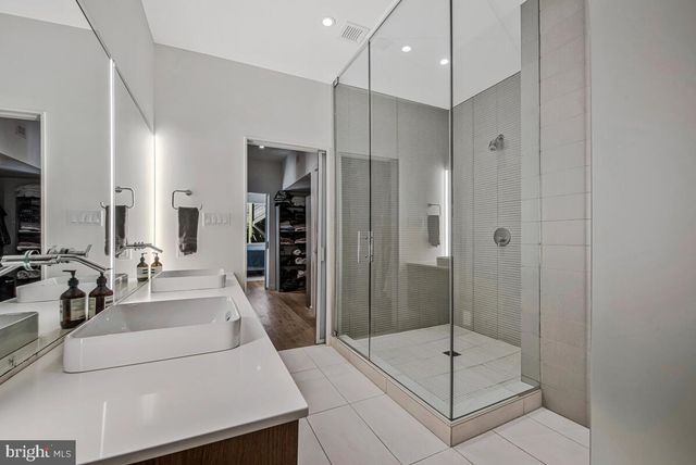 a bathroom with a shower sink and mirror