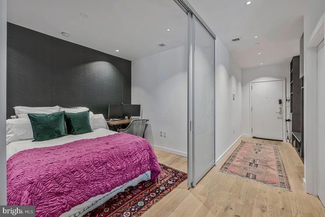 a bedroom with a bed and a chandelier