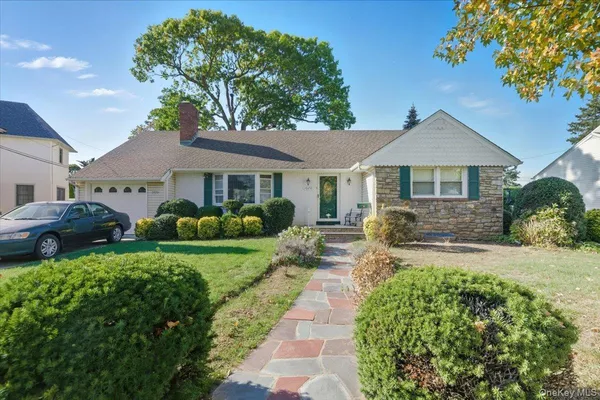 a front view of a house with a garden