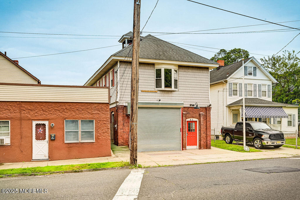 95 Broadway Keyport, NJ 07735 - Photo 1 of 31 a front view of a house with a garden and garage
