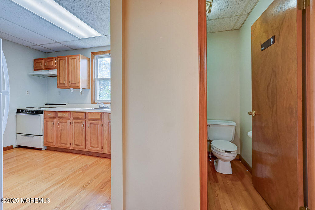 95 Broadway Keyport, NJ 07735 - Photo 16 of 31 a bathroom with a granite countertop sink a toilet a mirror and shower