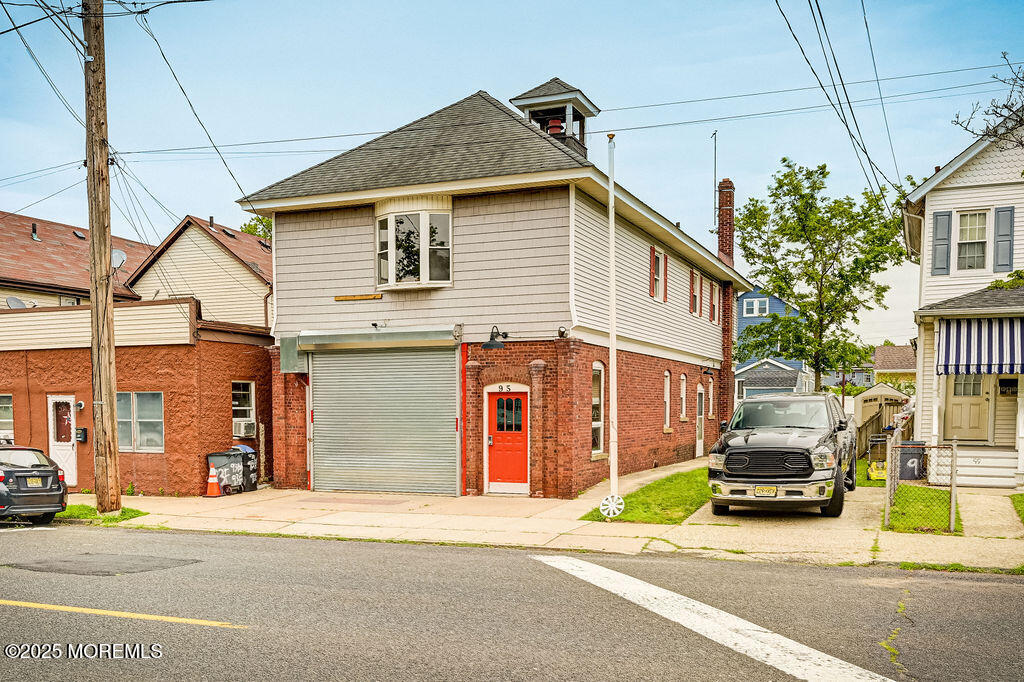 95 Broadway Keyport, NJ 07735 - Photo 3 of 31 a front view of a house with a garden and parking