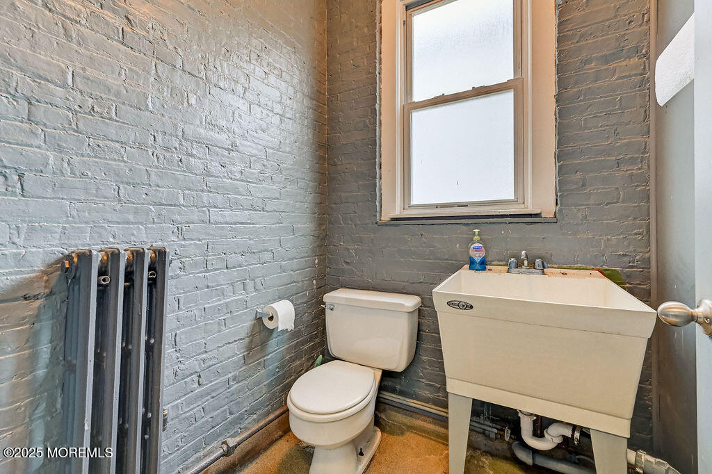 95 Broadway Keyport, NJ 07735 - Photo 9 of 31 a bathroom with a toilet sink and mirror