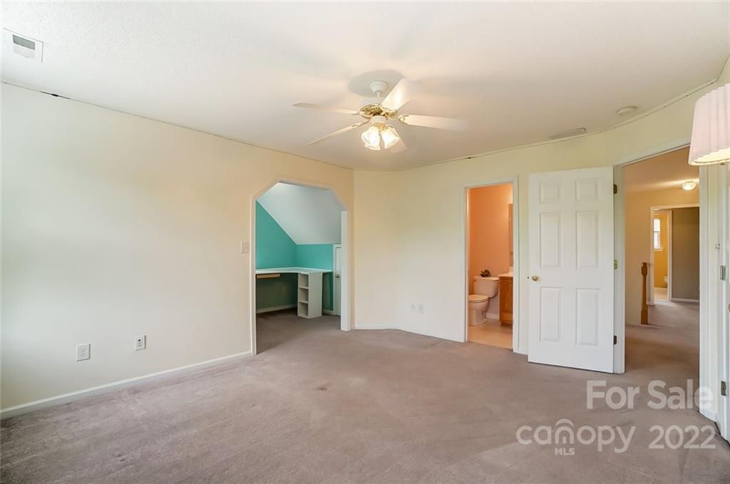 104 High Ridge Court West Mount Holly, NC 28120 - Photo 20 of 34 an empty room with a ceiling fan and a walk in closet