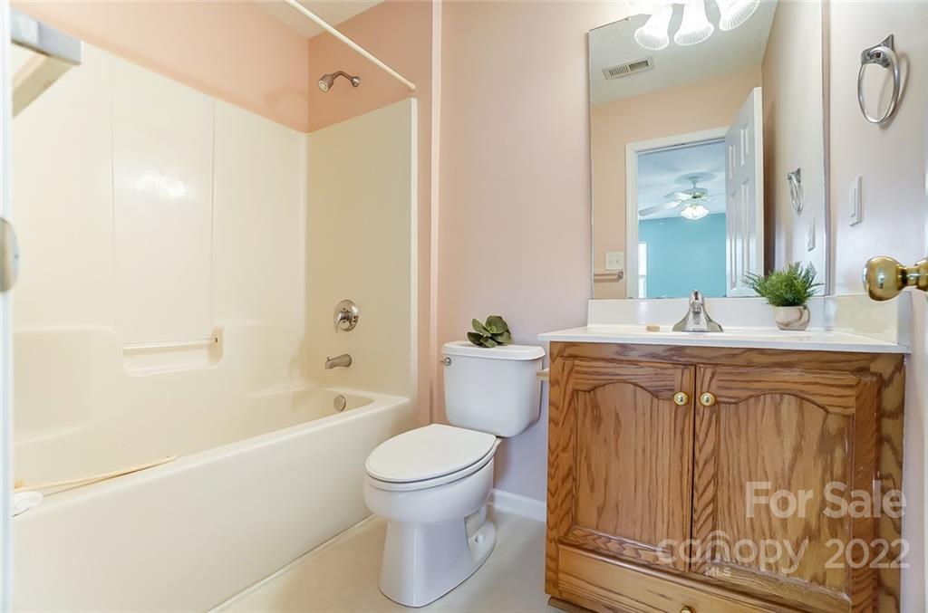 104 High Ridge Court West Mount Holly, NC 28120 - Photo 21 of 34 a bathroom with a granite countertop sink toilet and shower