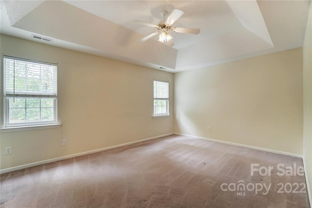 104 High Ridge Court West Mount Holly, NC 28120 - Photo 22 of 34 an empty room with windows and fan