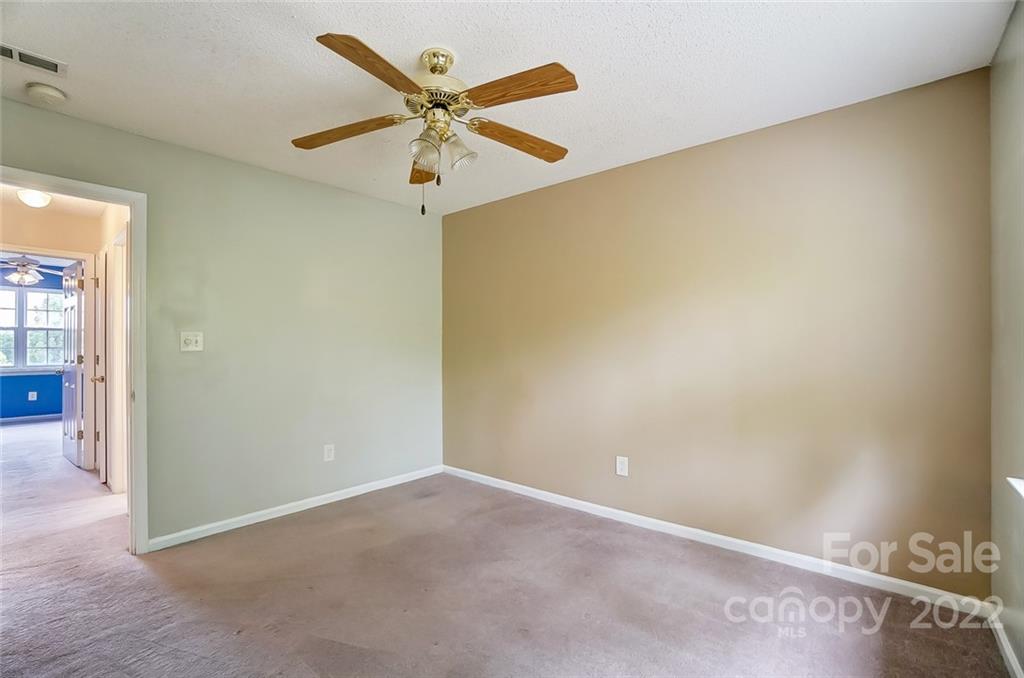 104 High Ridge Court West Mount Holly, NC 28120 - Photo 28 of 34 an empty room with a ceiling fan and a window