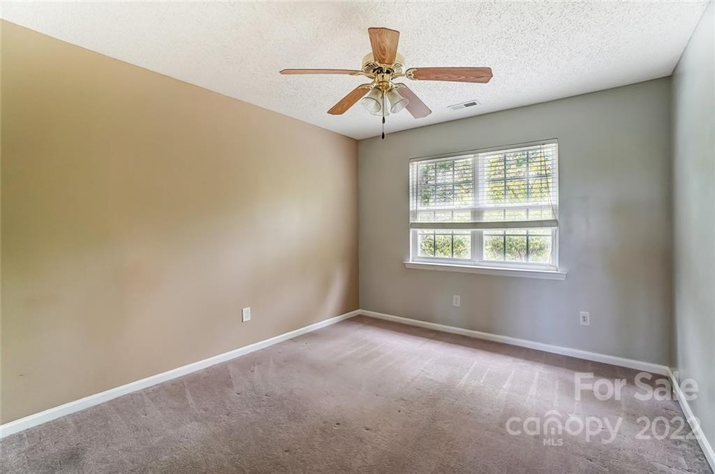 104 High Ridge Court West Mount Holly, NC 28120 - Photo 5 of 34 an empty room with windows and fan