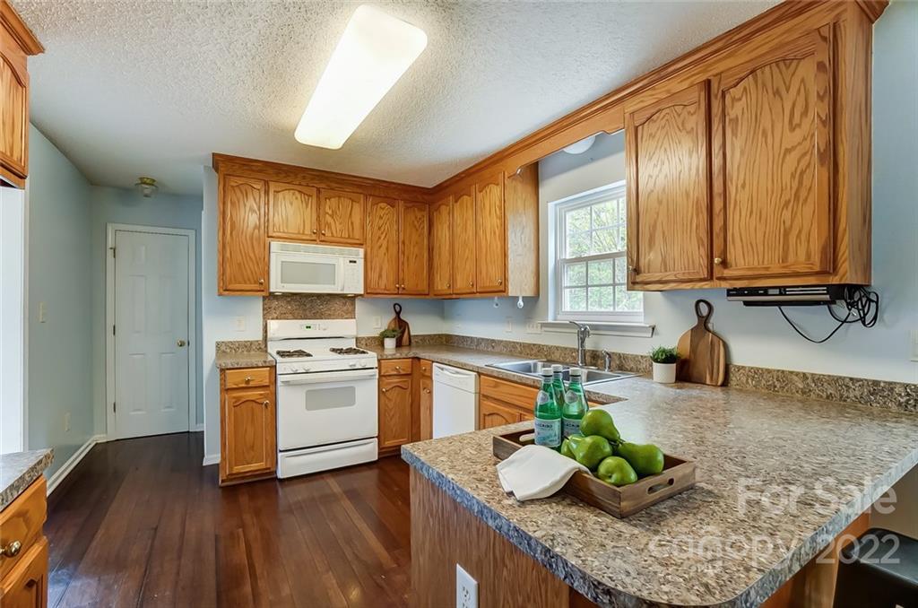 104 High Ridge Court West Mount Holly, NC 28120 - Photo 8 of 34 a kitchen with granite countertop wooden floors and sink