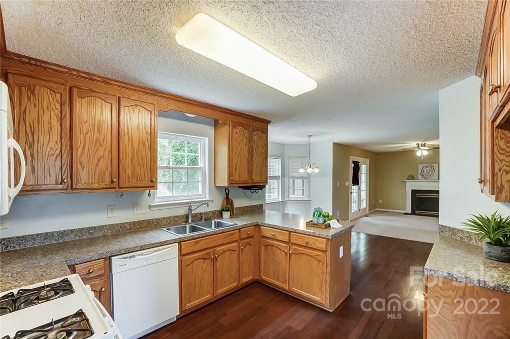104 High Ridge Court West Mount Holly, NC 28120 - Photo 10 of 34 a kitchen with granite countertop a stove a sink and a granite counter top