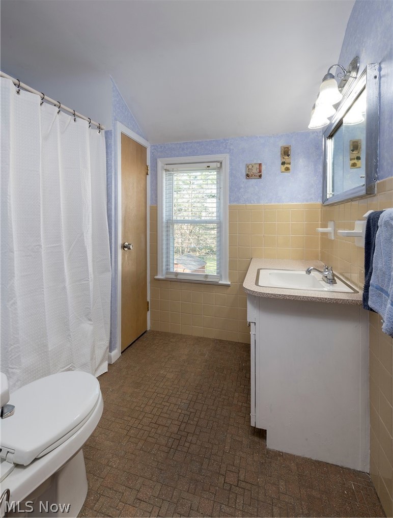 1170 Roland Road Lyndhurst, OH 44124 - Photo 23 of 36 Bathroom featuring vanity, tile walls, lofted ceiling, toilet, and tile flooring
