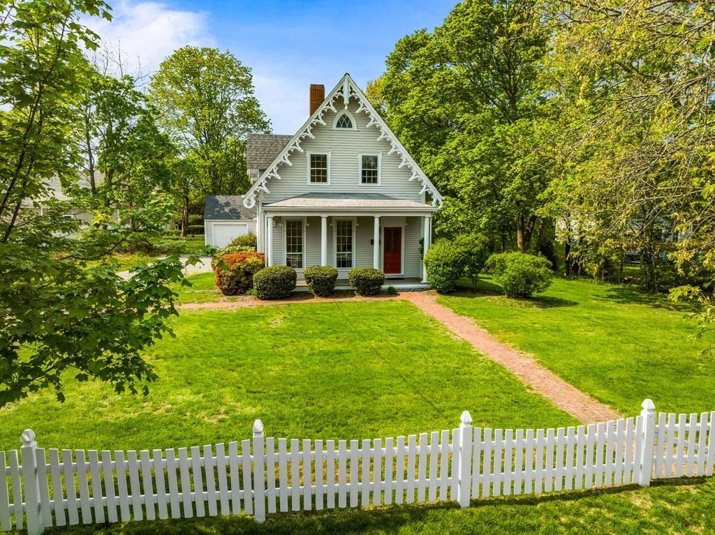 59 Cottage Street Hingham, MA 02043 - Photo 1 of 28 a front view of a house with a yard table and chairs