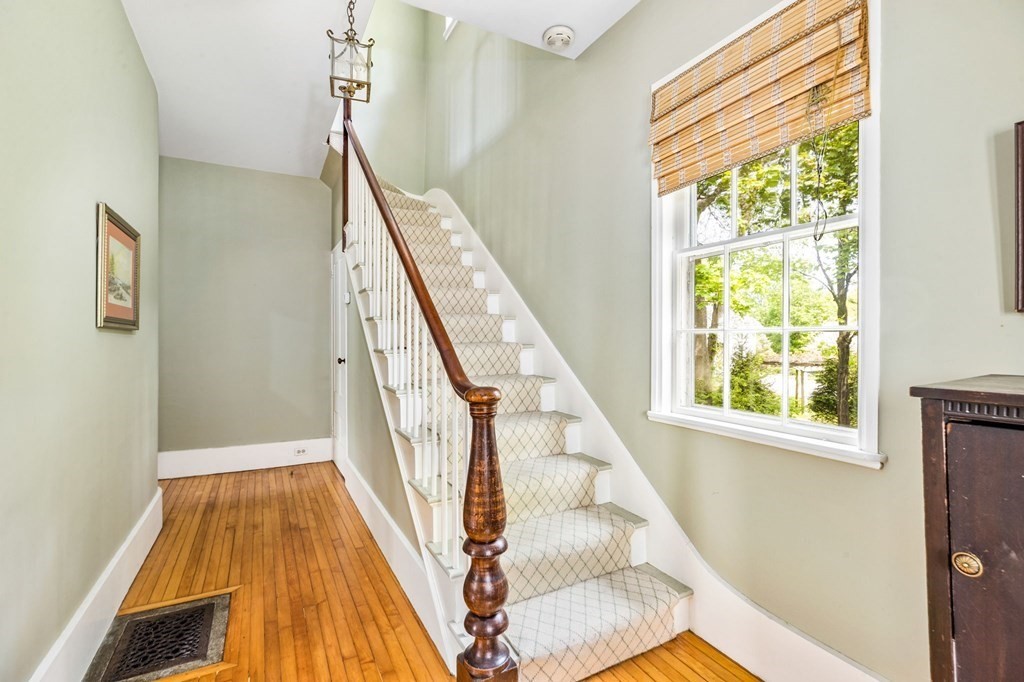 59 Cottage Street Hingham, MA 02043 - Photo 13 of 28 a view of a hallway with wooden floor and staircase