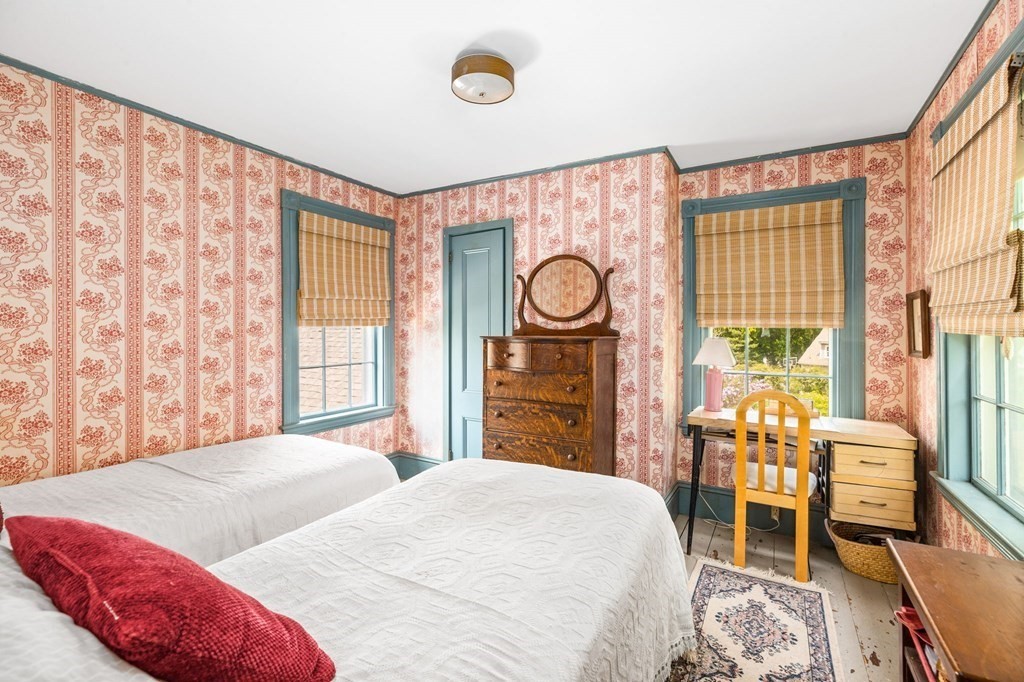 59 Cottage Street Hingham, MA 02043 - Photo 19 of 28 a bedroom with a bed and a table next to a window