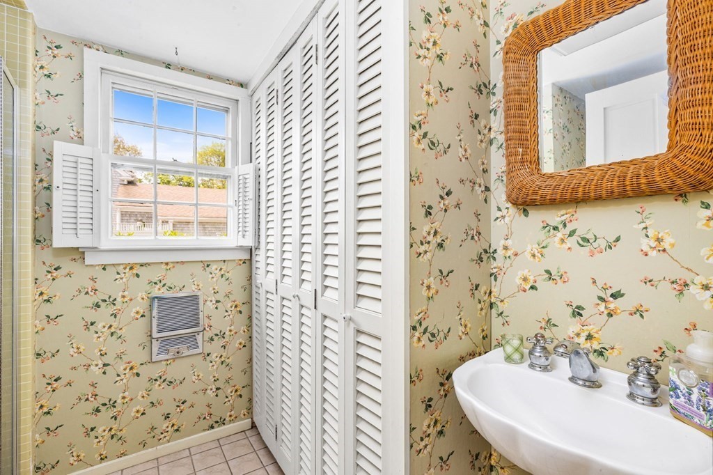 59 Cottage Street Hingham, MA 02043 - Photo 10 of 28 a bathroom with a sink and a mirror