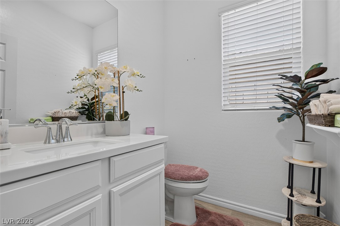 1824 Redland Ridge Street Henderson, NV 89002 - Photo 19 of 69 A well-lit powder room featuring a bright vanity and convenient window blinds.