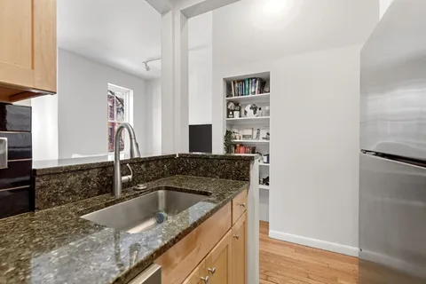 a kitchen with a sink and a refrigerator