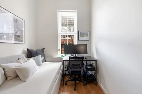 a bedroom with a bed and a flat screen tv