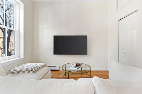 a bedroom with furniture and a flat screen tv
