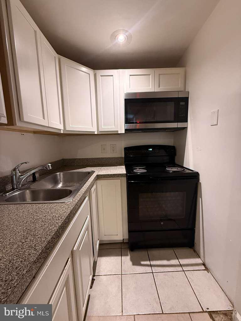 5923 Berwyn Road College Park, MD 20740 - Photo 34 of 51 a kitchen with a sink stove and cabinets