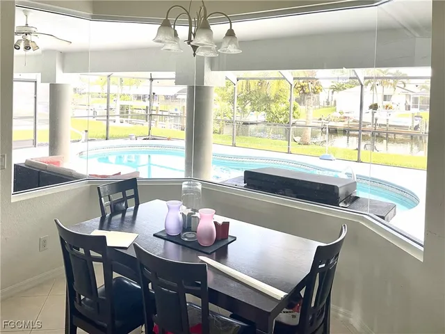 a dining room with furniture a chandelier and wooden floor