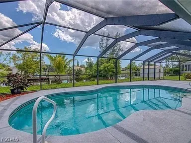 a view of a backyard with swimming pool
