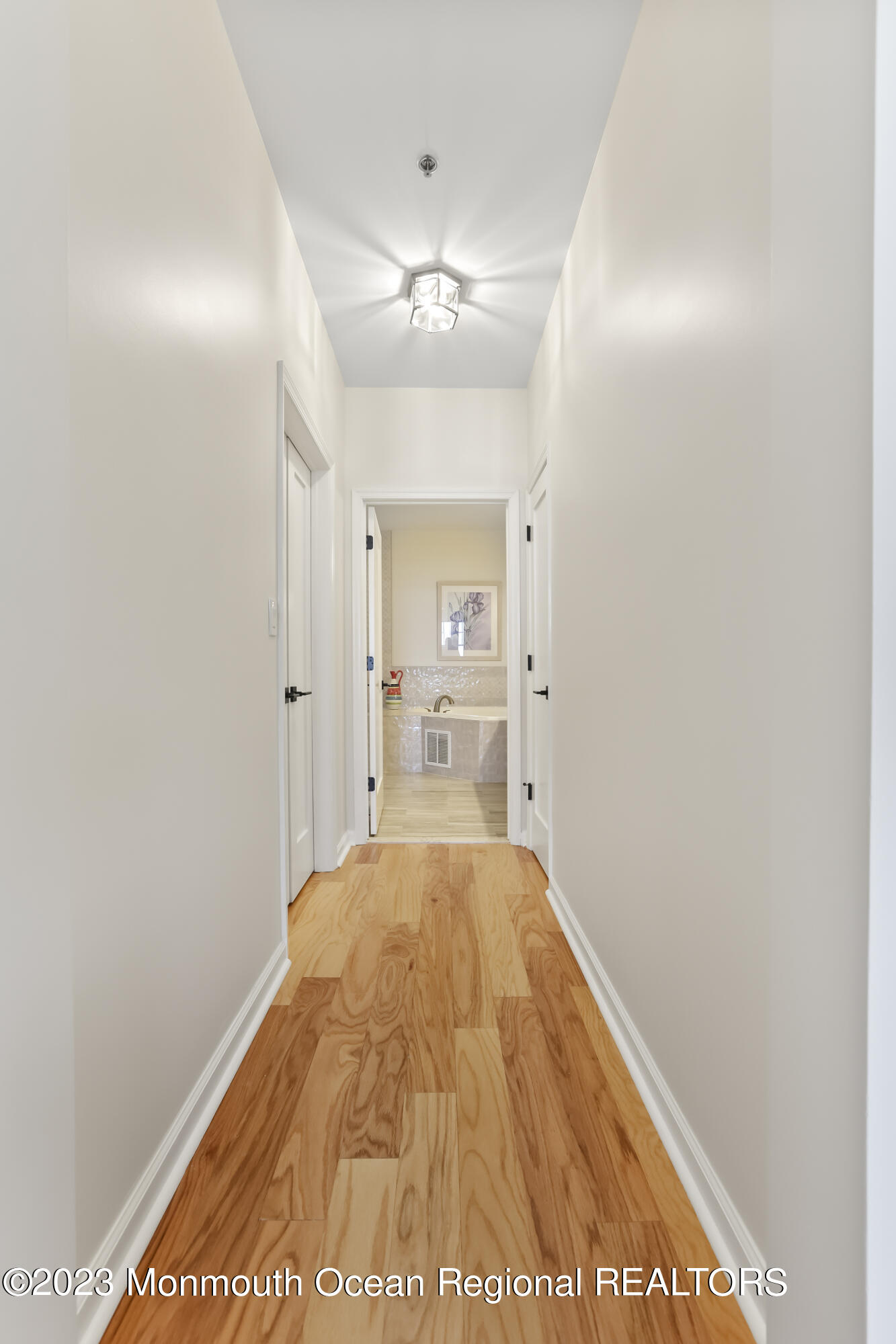 22 Cooper Avenue, Unit 309 Long Branch, NJ 07740 - Photo 13 of 52 a view of hallway with wooden floor