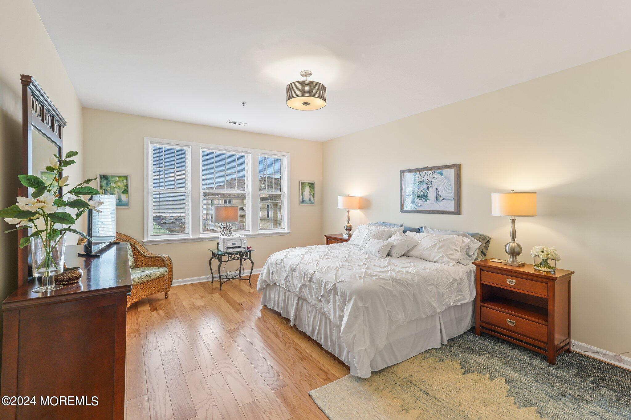 22 Cooper Avenue, Unit 309 Long Branch, NJ 07740 - Photo 14 of 52 a bedroom with a bed and a table