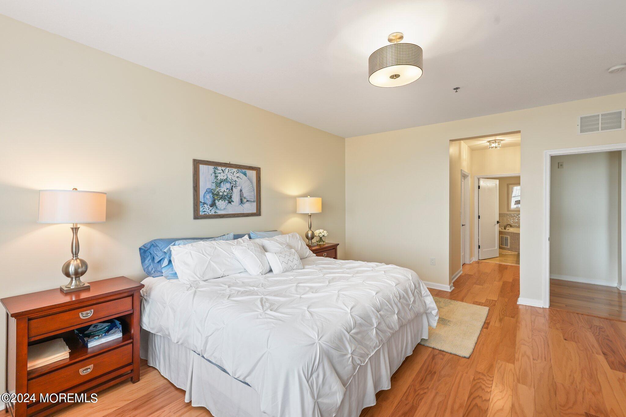 22 Cooper Avenue, Unit 309 Long Branch, NJ 07740 - Photo 15 of 52 a bedroom with a bed and a lamp