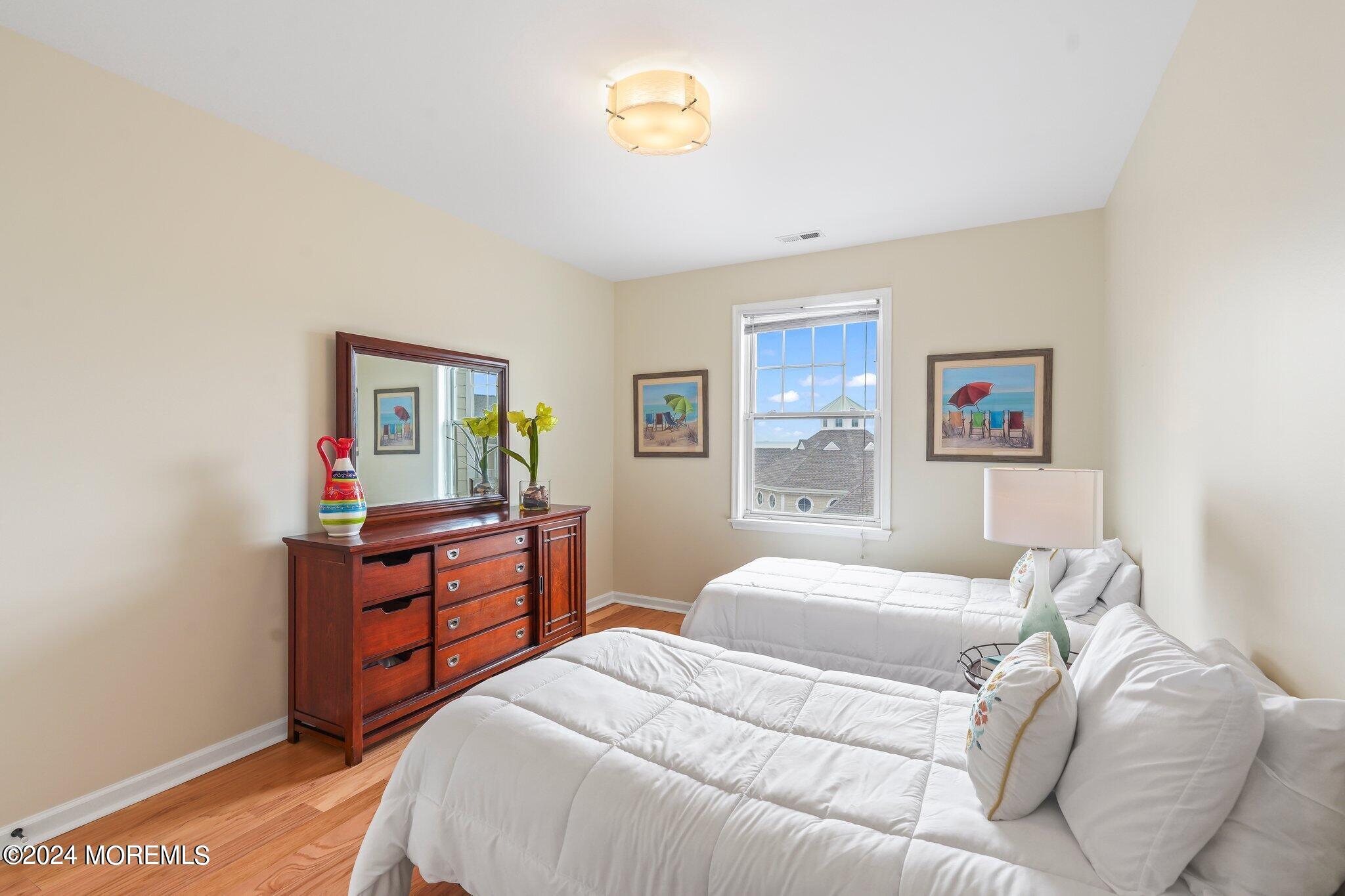 22 Cooper Avenue, Unit 309 Long Branch, NJ 07740 - Photo 16 of 52 a bedroom with a bed and a dresser in it