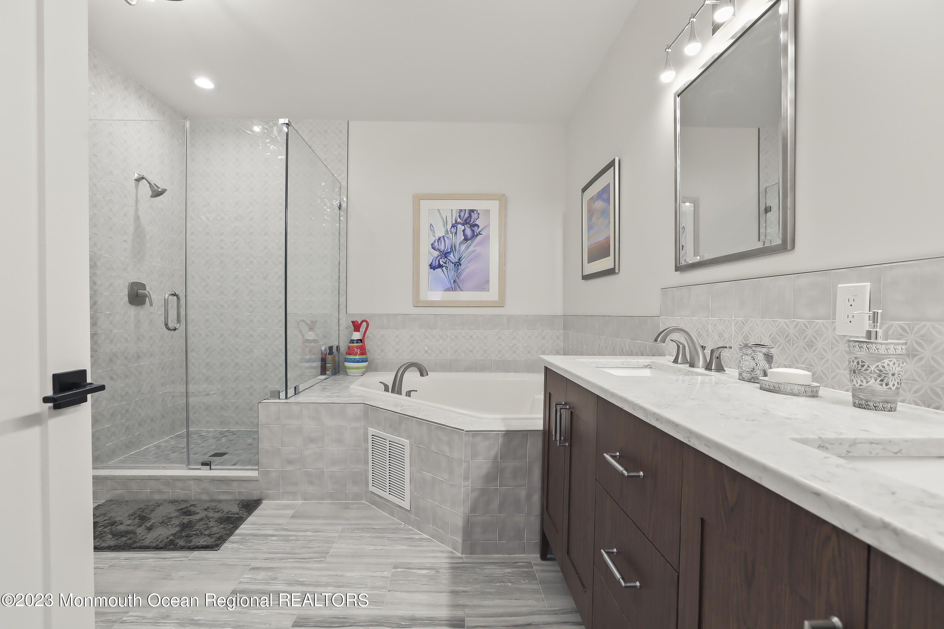22 Cooper Avenue, Unit 309 Long Branch, NJ 07740 - Photo 19 of 52 a bathroom with a tub sink and mirror