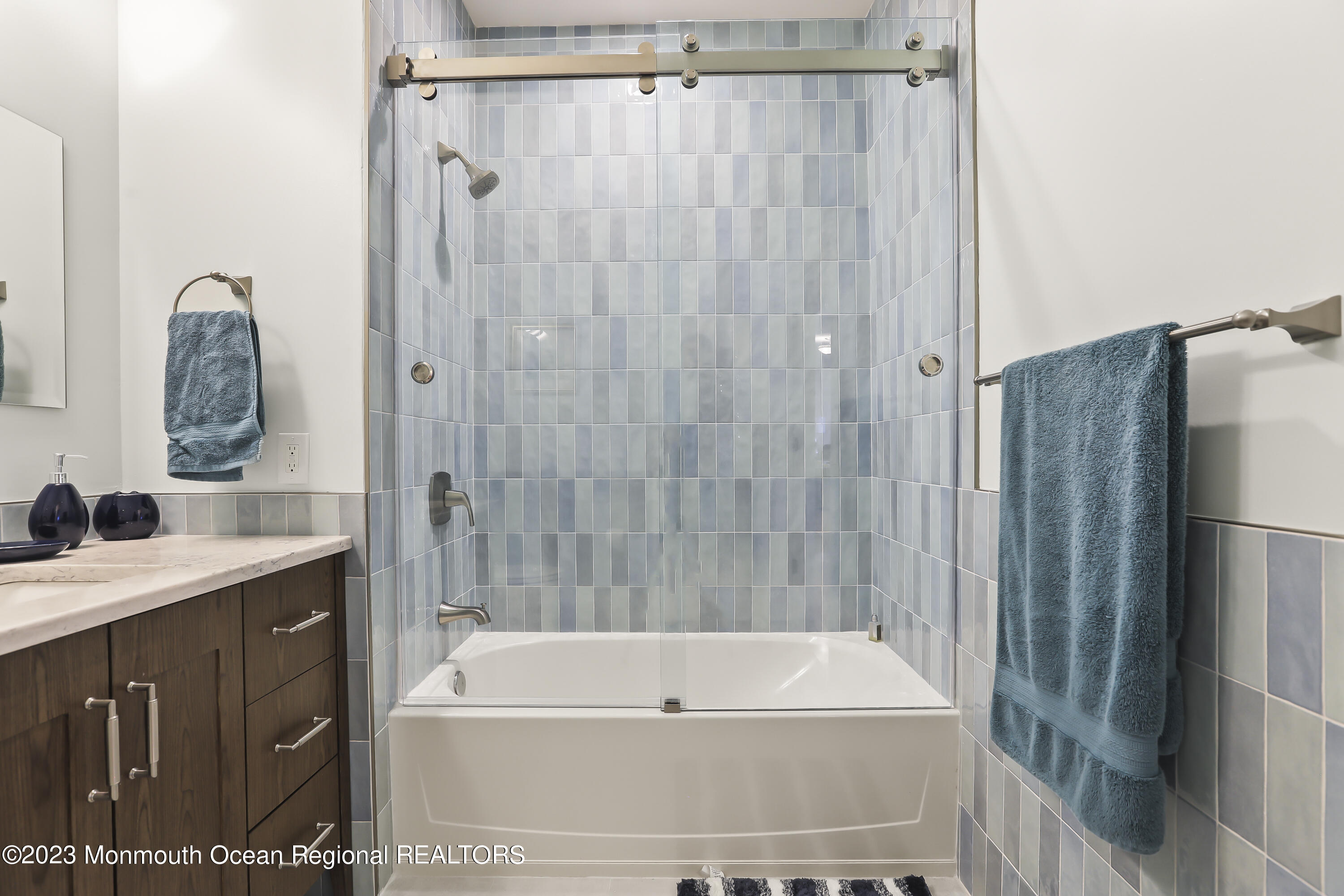 22 Cooper Avenue, Unit 309 Long Branch, NJ 07740 - Photo 21 of 52 a bathroom with a tub a sink and a shower
