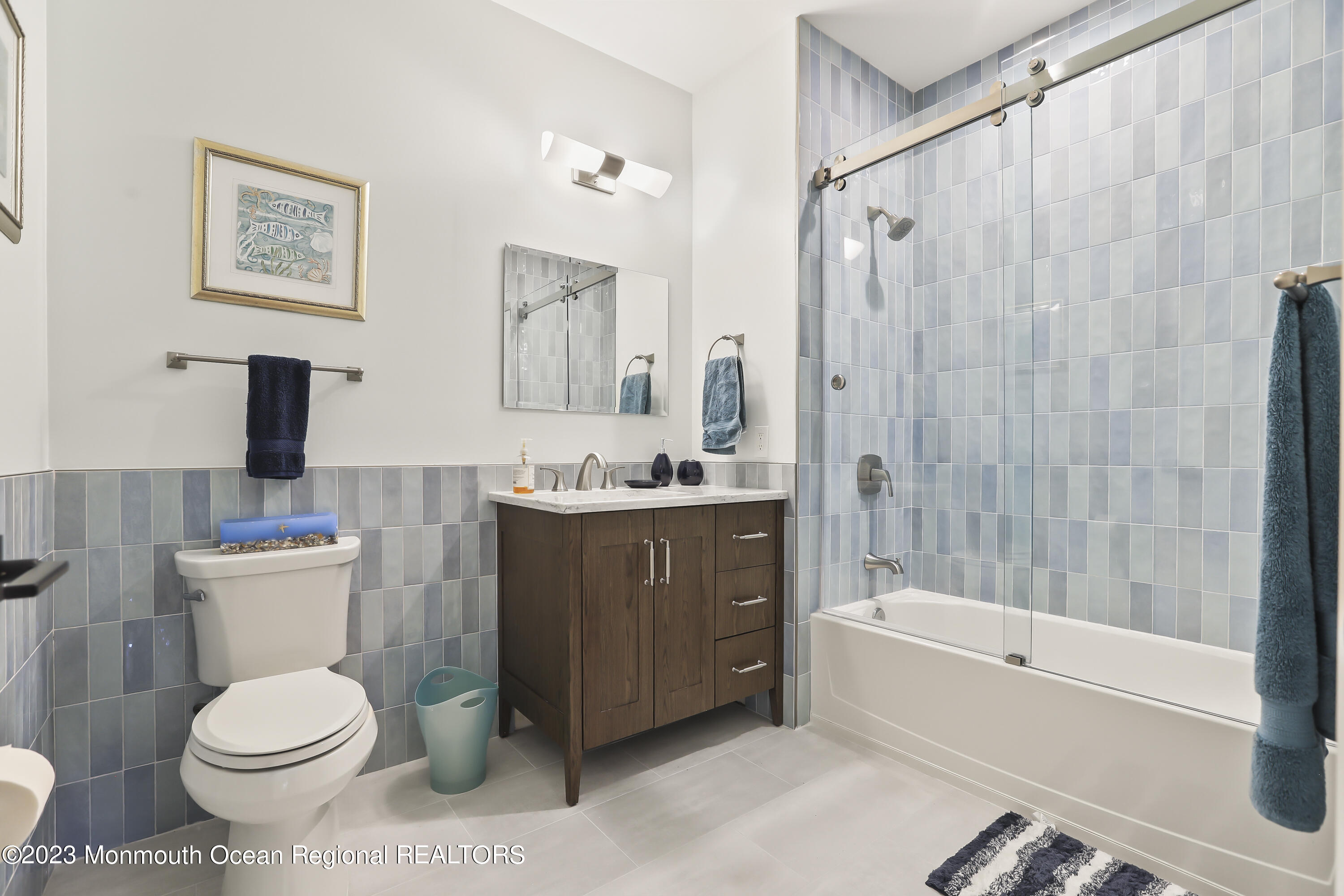22 Cooper Avenue, Unit 309 Long Branch, NJ 07740 - Photo 22 of 52 a bathroom with a sink a toilet and shower