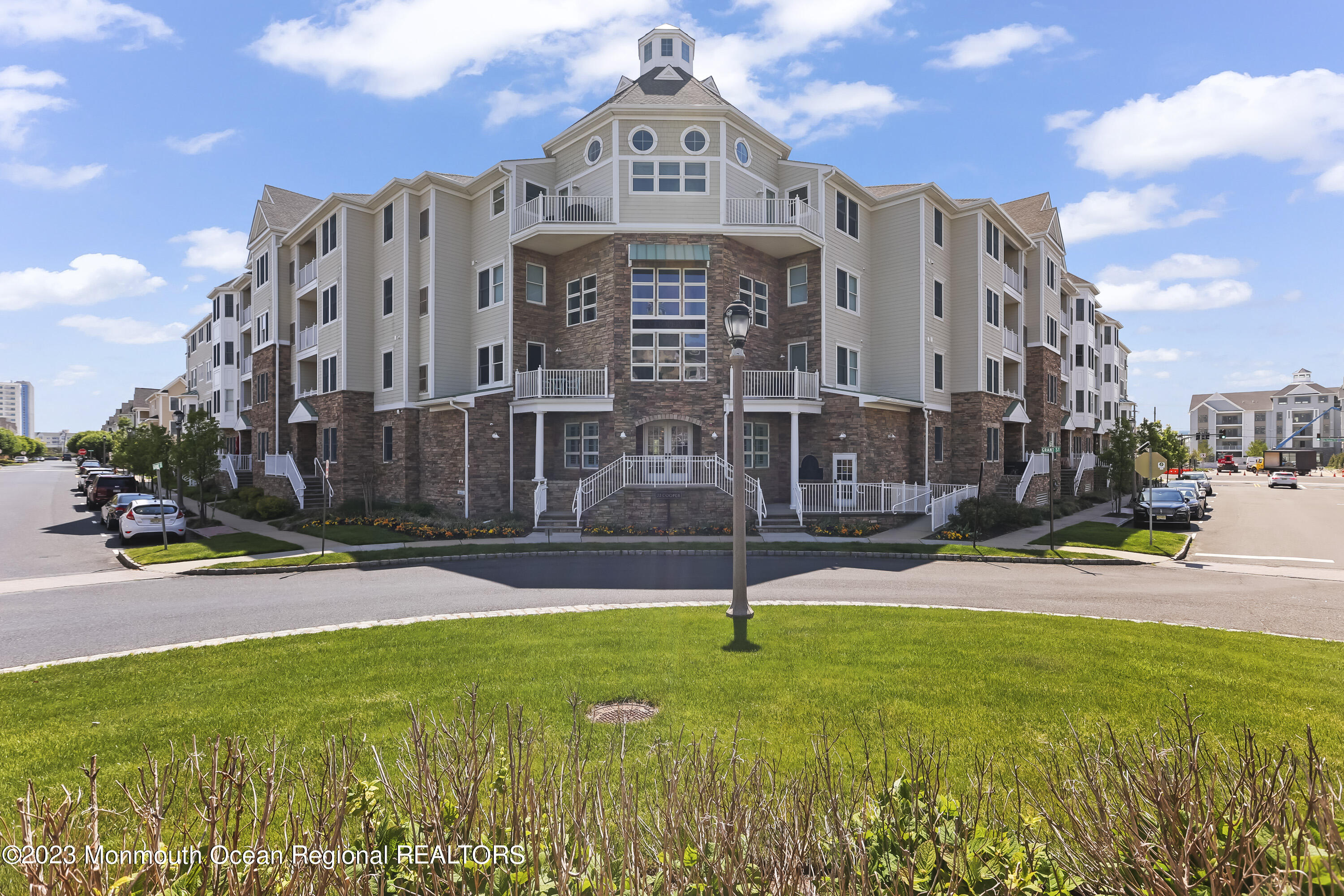 22 Cooper Avenue, Unit 309 Long Branch, NJ 07740 - Photo 25 of 52 a view of a building with a yard