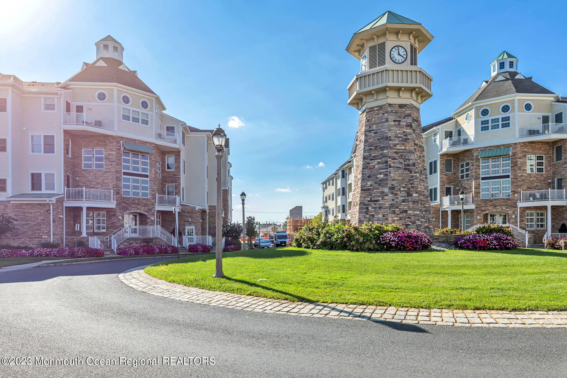 22 Cooper Avenue, Unit 309 Long Branch, NJ 07740 - Photo 40 of 52 a front view of a residential apartment building with a yard