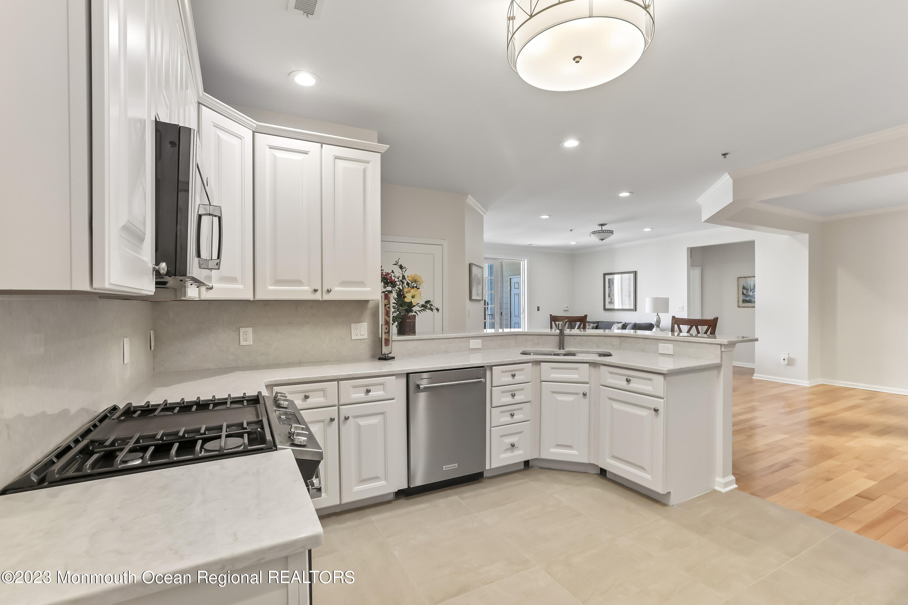 22 Cooper Avenue, Unit 309 Long Branch, NJ 07740 - Photo 5 of 52 a kitchen with white cabinets and white appliances