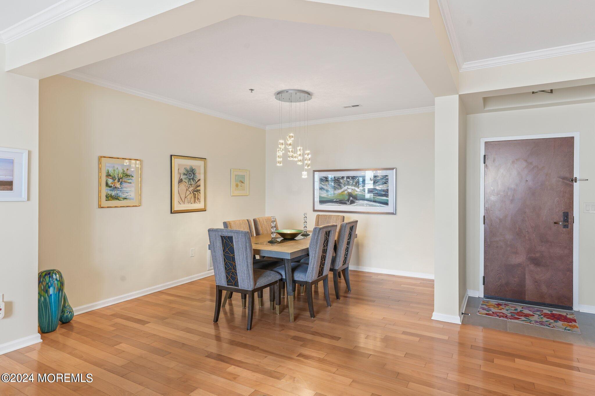22 Cooper Avenue, Unit 309 Long Branch, NJ 07740 - Photo 8 of 52 a view of a dining room with furniture and wooden floor